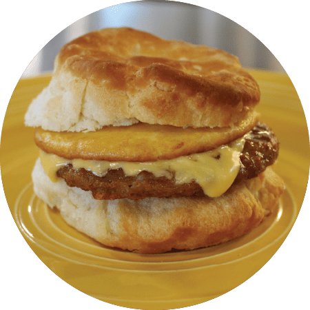 Sausage breakfast sandwich on flaky biscuit
