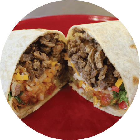 Steak burrito on handmade tortilla cut in half