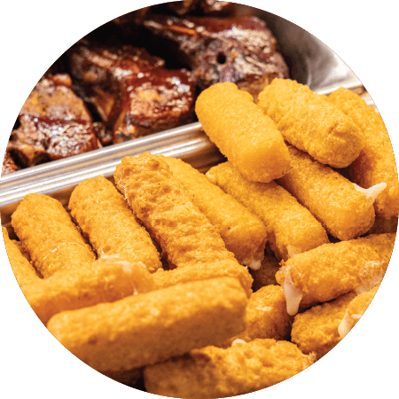 Fresh hot cheeseticks and ribs in deli hot case